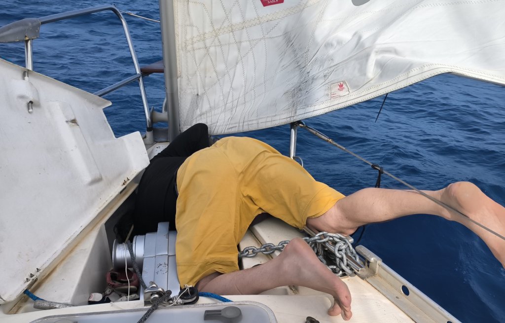 Sven hanging in the anchor locker upside down.