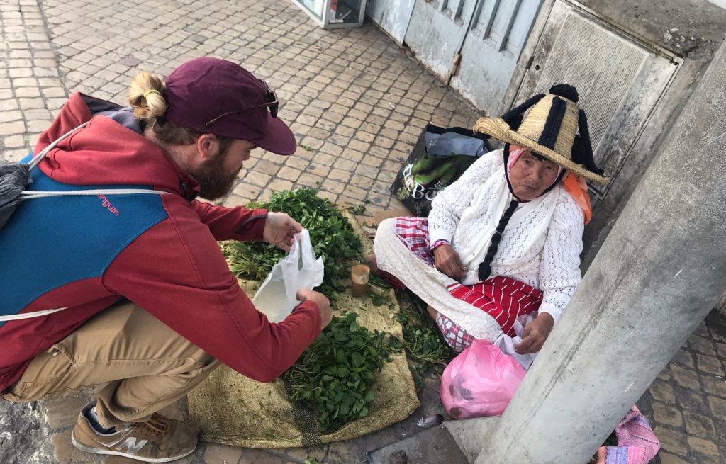 Thierry buying some peppermint off a lady on the street.