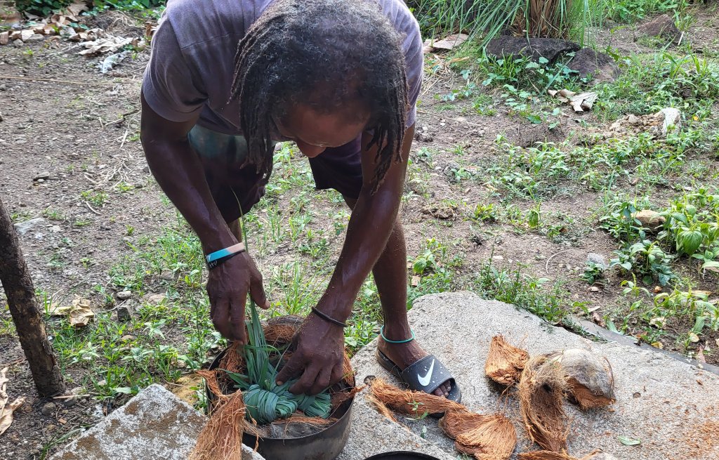 Filipo preparing the anti-mosquito pot.