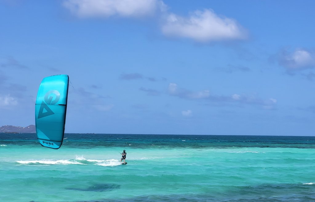 Captain flying over the turquoise coloured water.