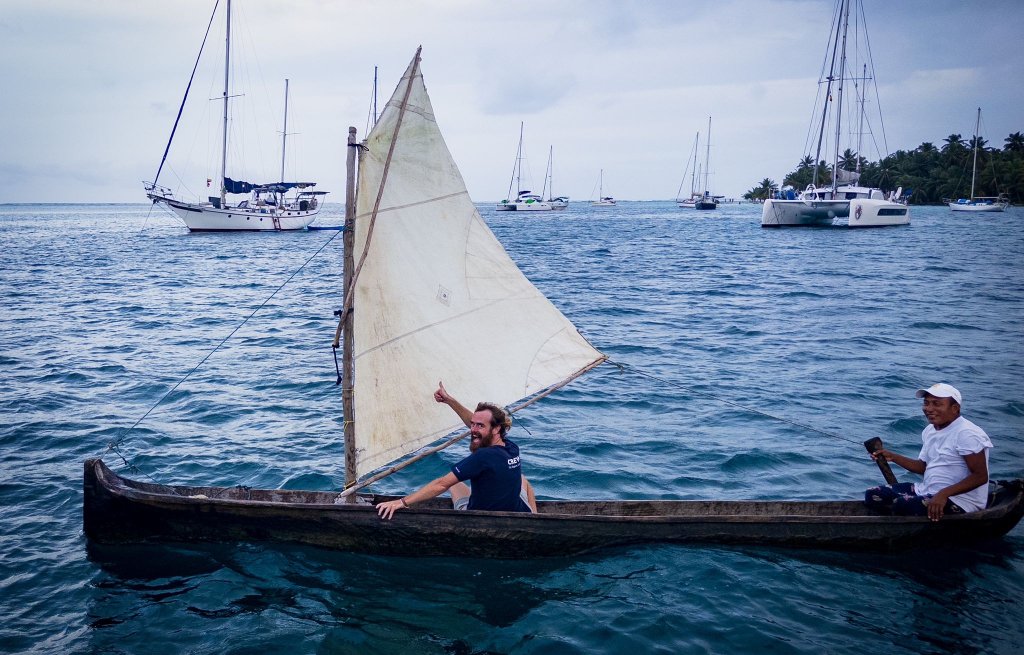 Thierry sailing through the bay with a local in his traditional canoe.
