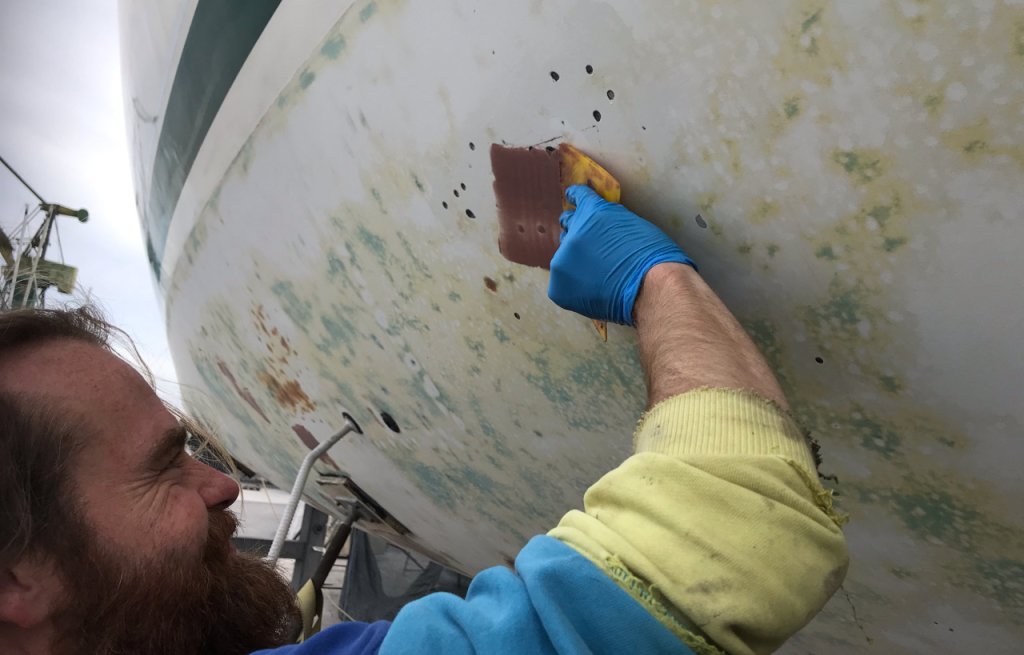 Fairing of blisters with thickened epoxy.